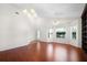 Spacious living room with hardwood floors, fan, chandelier and bright windows at 549 Coral Trace Blvd, Edgewater, FL 32132