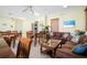View of a communal room with tables, chairs, sofas, tropical plants, and beach-themed decor at 549 Coral Trace Blvd, Edgewater, FL 32132
