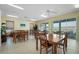 A communal meeting room with lots of table space and light from the sliding glass doors at 549 Coral Trace Blvd, Edgewater, FL 32132