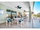 The pool patio with tables, chairs, and ceiling fans, providing a comfortable space to relax at 549 Coral Trace Blvd, Edgewater, FL 32132