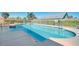 A well-maintained pool with clear blue water, surrounded by a concrete deck and a white fence at 549 Coral Trace Blvd, Edgewater, FL 32132