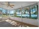 Screened in porch with a ceiling fan overlooking a beautiful lake at 549 Coral Trace Blvd, Edgewater, FL 32132
