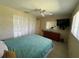 Cozy bedroom featuring a ceiling fan, mounted TV, and built-in wardrobe for ample storage at 630 Yupon Ave, New Smyrna Beach, FL 32169