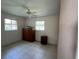 Bedroom with a ceiling fan and two windows that bring in ample natural light at 630 Yupon Ave, New Smyrna Beach, FL 32169