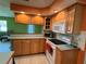 Cozy kitchen featuring wood cabinets, modern appliances, and tile countertops at 630 Yupon Ave, New Smyrna Beach, FL 32169