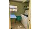 Laundry room with washer, dryer, folding table, and ample storage space at 630 Yupon Ave, New Smyrna Beach, FL 32169