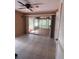Sunroom with tiled floors and walls of windows to let the light flood in at 630 Yupon Ave, New Smyrna Beach, FL 32169