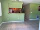 Living room with tile floors, a ceiling fan, and an open view into the kitchen at 630 Yupon Ave, New Smyrna Beach, FL 32169