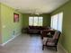 Comfortable living room featuring tile flooring, a ceiling fan, and ample seating at 630 Yupon Ave, New Smyrna Beach, FL 32169