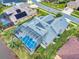 Aerial view of a single-Gathering home with solar panels, screened lanai, lush landscaping, and a private pool at 6665 Merryvale Ln, Port Orange, FL 32128