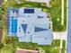 Aerial view of a single-Gathering home featuring solar panels, screened lanai, lush landscaping, and a private pool at 6665 Merryvale Ln, Port Orange, FL 32128