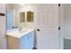 Bright bathroom with a white vanity, silver hardware, and a framed mirror at 6665 Merryvale Ln, Port Orange, FL 32128