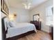 Well-lit bedroom with a large bed, dark wood furniture, and a ceiling fan providing a comfortable and inviting space at 6665 Merryvale Ln, Port Orange, FL 32128
