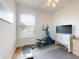 This bedroom is set up as a fitness room with an elliptical and other exercise equipment and ceiling fan at 6665 Merryvale Ln, Port Orange, FL 32128