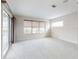 Spacious carpeted bedroom with large windows offering natural light and a sliding glass door to a patio at 6665 Merryvale Ln, Port Orange, FL 32128