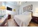 Bright bedroom featuring hardwood floors, a ceiling fan, TV, and comfortable furnishings at 6665 Merryvale Ln, Port Orange, FL 32128