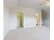 Large bonus room with two doorways and plush neutral carpet at 6665 Merryvale Ln, Port Orange, FL 32128