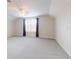 Bright bonus room with large windows and ceiling fan at 6665 Merryvale Ln, Port Orange, FL 32128