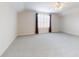 Spacious carpeted bonus room with large windows and a ceiling fan at 6665 Merryvale Ln, Port Orange, FL 32128