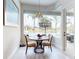 Bright breakfast nook with modern chandelier and views of the pool and lake at 6665 Merryvale Ln, Port Orange, FL 32128