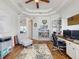 Well-lit home office with custom built-ins and a comfortable chair, perfect for productivity at 6665 Merryvale Ln, Port Orange, FL 32128