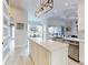 Open concept kitchen with a large island, stainless steel appliances, and a breakfast nook with natural light at 6665 Merryvale Ln, Port Orange, FL 32128