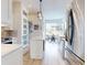 Bright open concept kitchen and dining area features stainless steel appliances and light cabinetry at 6665 Merryvale Ln, Port Orange, FL 32128