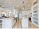 Open concept kitchen with a large island, stainless steel appliances, and modern lighting fixtures at 6665 Merryvale Ln, Port Orange, FL 32128