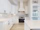 Bright kitchen features white cabinetry, stainless steel appliances, and a pantry door with frosted glass at 6665 Merryvale Ln, Port Orange, FL 32128