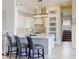 Bright kitchen featuring a large island with seating and a decorative tile backsplash at 6665 Merryvale Ln, Port Orange, FL 32128