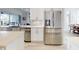 Modern kitchen with stainless steel appliances, sleek white cabinets, and an island overlooking the dining area at 6665 Merryvale Ln, Port Orange, FL 32128