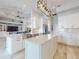 Spacious kitchen with stainless steel appliances, an island, and modern white cabinets with dark hardware at 6665 Merryvale Ln, Port Orange, FL 32128