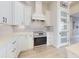 Bright kitchen features white cabinetry, stainless steel appliances, and a pantry door with frosted glass at 6665 Merryvale Ln, Port Orange, FL 32128