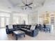 Open-concept living room with modern lighting, and open access to the kitchen and dining area at 6665 Merryvale Ln, Port Orange, FL 32128