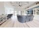 Open-concept living room with entertainment center, fireplace, and access to outdoor patio at 6665 Merryvale Ln, Port Orange, FL 32128