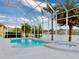 Beautiful pool within a screened enclosure with views of a tranquil lake and manicured landscaping at 6665 Merryvale Ln, Port Orange, FL 32128