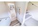 Carpeted staircase leading to a light and airy hallway with stylish decor at 6665 Merryvale Ln, Port Orange, FL 32128