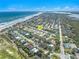 An aerial view of a home near the ocean, with golf course, and beach access at 72 Oceanview Ave, Ponce Inlet, FL 32127