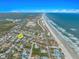 Aerial view of a coastal neighborhood featuring a home near the beach with beautiful ocean views at 72 Oceanview Ave, Ponce Inlet, FL 32127