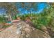 Secluded backyard oasis featuring lush landscaping, a pool, and decorative stepping stones at 72 Oceanview Ave, Ponce Inlet, FL 32127