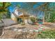 Private backyard with a pool, patio seating area, and mature trees at 72 Oceanview Ave, Ponce Inlet, FL 32127
