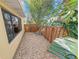 View of the backyard with a gravel area, fence, and tropical vegetation at 72 Oceanview Ave, Ponce Inlet, FL 32127