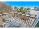Outdoor deck with chairs overlooking the surrounding trees and rooftops under a bright blue sky at 72 Oceanview Ave, Ponce Inlet, FL 32127