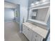 Bright bathroom featuring a single sink vanity, updated fixtures, and storage at 72 Oceanview Ave, Ponce Inlet, FL 32127