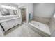 Elegant bathroom with dual sinks, soaking tub, and walk-in shower at 72 Oceanview Ave, Ponce Inlet, FL 32127