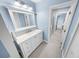 Inviting bathroom with double doors, a stylish vanity, and a view of the adjacent shower and bedroom at 72 Oceanview Ave, Ponce Inlet, FL 32127