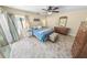 Bedroom with ceiling fan, wood floors, and sliding glass door access to outdoor patio at 72 Oceanview Ave, Ponce Inlet, FL 32127
