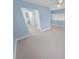 Spacious bedroom with neutral carpet, open doorway, and blue walls at 72 Oceanview Ave, Ponce Inlet, FL 32127