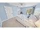 Light blue bedroom with a ceiling fan and sliding glass doors leading to a private balcony at 72 Oceanview Ave, Ponce Inlet, FL 32127