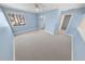 Large bedroom featuring a ceiling fan, big windows, and blue walls at 72 Oceanview Ave, Ponce Inlet, FL 32127
